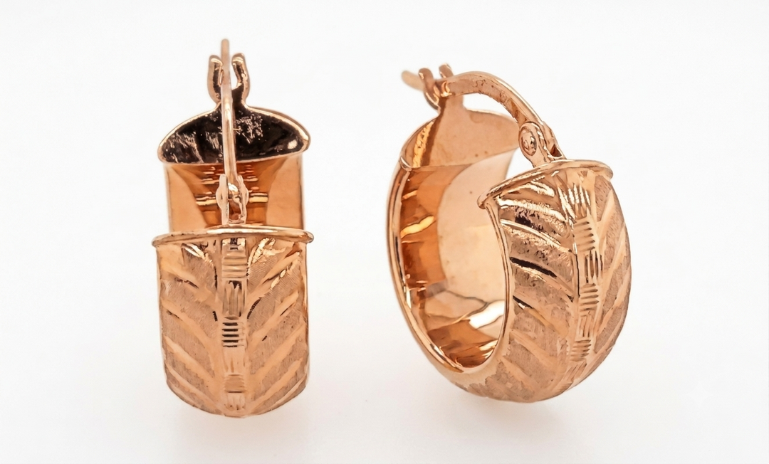 Rose gold huggie hoop earrings with intricate designs