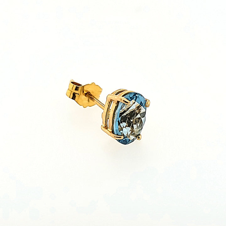 Oval Blue Topaz Studs in 14k Gold